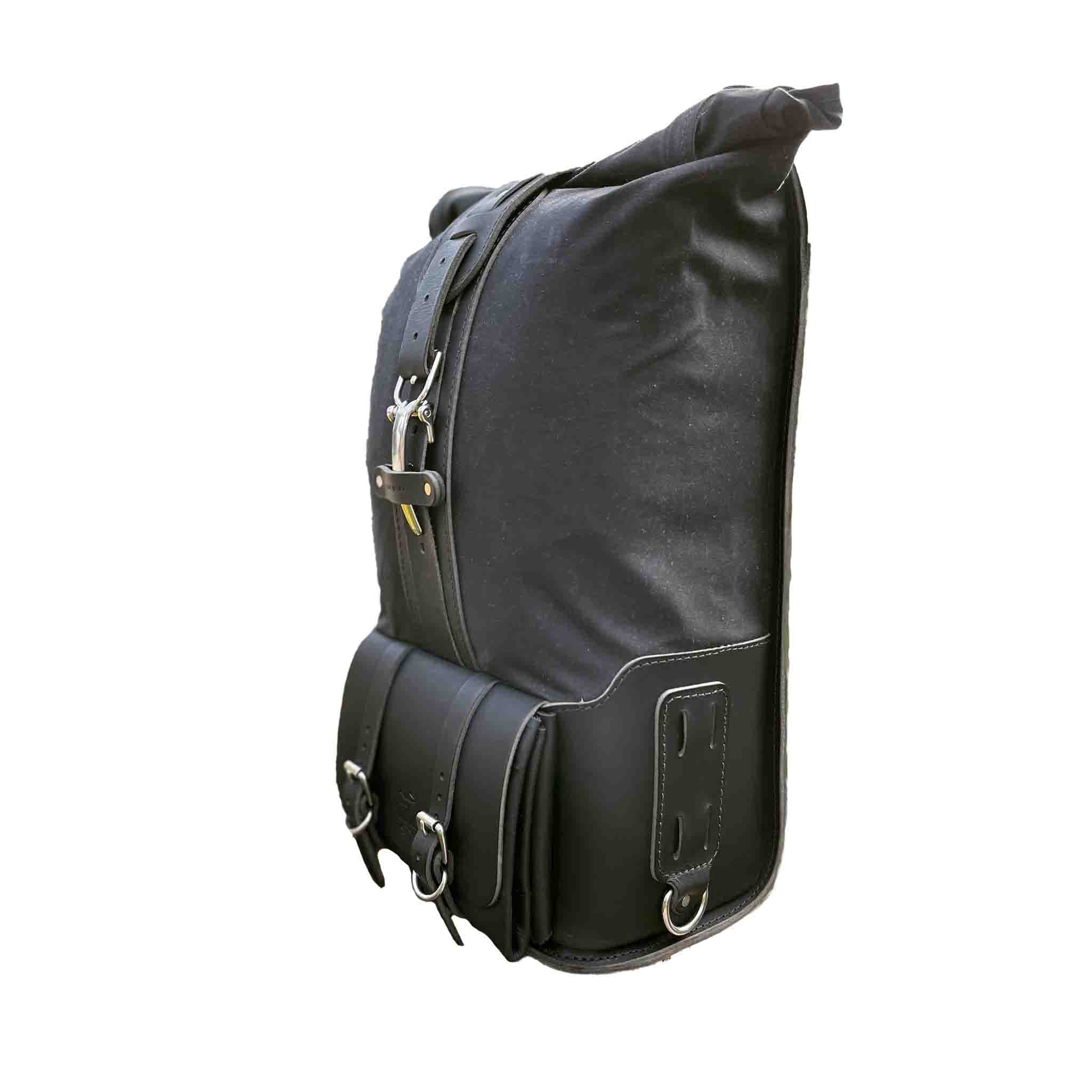Upgrade your ride with the URB03 Rolltop Backpack Saddlebag. Unique design enables quick conversion from saddlebag to backpack. Hand crafted in USA with premium veg tan water buffalo leather, waxed canvas and stainless steel hardware. Durable and stylish, it's the perfect fit for your motorcycle.