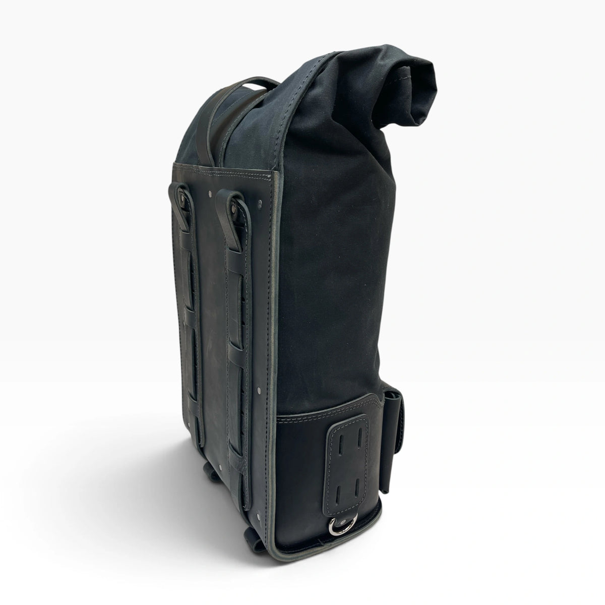 A black roll-top backpack shown from a side profile view against a clean white background.